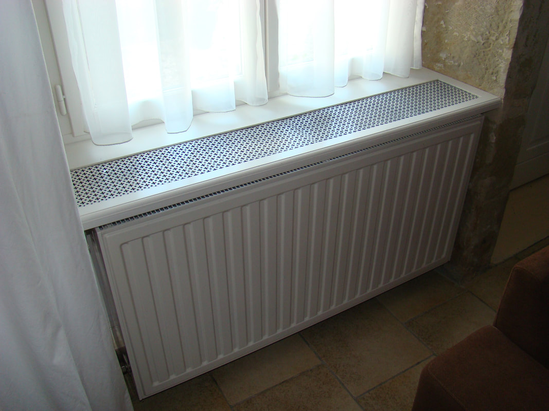 afb. 12.1.3 - 7b Rooster in vensterbank, hier bij een 'dikke' 32-radiator (3 platen, 2 ribelementen)